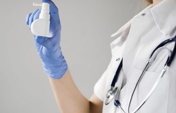 close-up-doctor-holding-mouth-spray